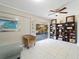 Bright living area with tile flooring, a ceiling fan, and sliding glass doors to the outdoor space at 18151 Cochran Blvd, Port Charlotte, FL 33948