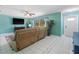 Comfortable living room featuring a plush sectional sofa, ceiling fan, and a bright window at 18151 Cochran Blvd, Port Charlotte, FL 33948