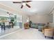 Inviting living room with tile floors, ceiling fan, and views into the kitchen and dining area at 18151 Cochran Blvd, Port Charlotte, FL 33948