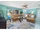 Inviting living room with a large sectional sofa, area rug, and ample natural light at 18151 Cochran Blvd, Port Charlotte, FL 33948