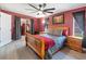 Bedroom with wood-look floors, large windows, and sliding doors to an outdoor area at 18151 Cochran Blvd, Port Charlotte, FL 33948