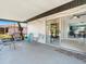 Covered patio featuring multiple chairs and sliding glass door leading to the home's interior at 18151 Cochran Blvd, Port Charlotte, FL 33948