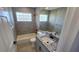 This is a bathroom with granite counters, tiled shower and a glass block window at 18519 Alphonse Cir, Port Charlotte, FL 33948