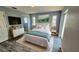 Tastefully decorated bedroom with neutral tones, featuring wood-look flooring, ensuite bathroom, and serene natural lighting at 18519 Alphonse Cir, Port Charlotte, FL 33948