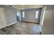 Bright bedroom with wood-look flooring and natural light, showcasing a doorway to the ensuite bathroom at 18519 Alphonse Cir, Port Charlotte, FL 33948