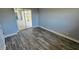 A bedroom with vinyl wood flooring with a screened in patio accessible via sliding glass door at 18519 Alphonse Cir, Port Charlotte, FL 33948
