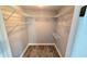 A walk in closet with multiple wire shelves and wood flooring at 18519 Alphonse Cir, Port Charlotte, FL 33948