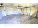 Spacious garage with shelving and an automatic garage door opener ready to park vehicles and store equipment at 18519 Alphonse Cir, Port Charlotte, FL 33948