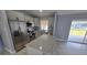 Modern kitchen featuring stainless steel appliances, granite countertops, and a functional island with an adjacent dining area at 18519 Alphonse Cir, Port Charlotte, FL 33948