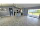 Open-concept interior featuring a kitchen with stainless steel appliances, an island, and a seamless flow to the living area at 18519 Alphonse Cir, Port Charlotte, FL 33948