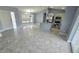 Well-lit interior showcasing a kitchen island and stainless steel appliances, blending into the open living space at 18519 Alphonse Cir, Port Charlotte, FL 33948