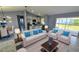Bright and stylish living room connected to an open kitchen, furnished with a modern dining set and comfortable seating at 18519 Alphonse Cir, Port Charlotte, FL 33948