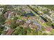 Aerial view of the well-maintained condo community surrounded by mature trees and water features at 19505 Quesada Ave # Pp201, Port Charlotte, FL 33948