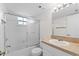 Bathroom featuring a shower and tub combination with glass doors, along with a vanity and sink at 19505 Quesada Ave # Pp201, Port Charlotte, FL 33948