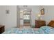 Bright bedroom featuring a quilted bed, a sliding mirror closet, and access to an ensuite bathroom at 19505 Quesada Ave # Pp201, Port Charlotte, FL 33948