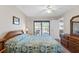 Relaxing bedroom featuring a quilted bed with access to a balcony and ample natural light at 19505 Quesada Ave # Pp201, Port Charlotte, FL 33948
