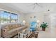 Bright living room showcasing tile flooring, a comfortable sofa, and a large window offering neighborhood views at 19505 Quesada Ave # Pp201, Port Charlotte, FL 33948