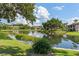 Scenic view of the calm pond reflecting the community buildings on a sunny day at 19505 Quesada Ave # Pp201, Port Charlotte, FL 33948