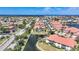 Aerial view of a home with a pond in the backyard in a community with manicured landscaping at 196 Tarpon Cove Blvd # 722, Punta Gorda, FL 33950