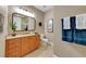 Bathroom boasting a wood vanity, tiled floors, and a framed mirror above the sink at 196 Tarpon Cove Blvd # 722, Punta Gorda, FL 33950