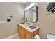 Well-lit bathroom featuring a wood vanity with ample storage and a tiled floor at 196 Tarpon Cove Blvd # 722, Punta Gorda, FL 33950