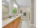 The bathroom features dual sinks, and a glass block shower for privacy at 196 Tarpon Cove Blvd # 722, Punta Gorda, FL 33950