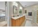 Bright bathroom featuring a double vanity, tiled floors, and a glass-enclosed shower at 196 Tarpon Cove Blvd # 722, Punta Gorda, FL 33950