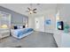 Bright bedroom showcasing neutral carpet, cool colors, and a ceiling fan at 196 Tarpon Cove Blvd # 722, Punta Gorda, FL 33950