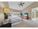 The bedroom features a vaulted ceiling, ceiling fan, and television with beach scene at 196 Tarpon Cove Blvd # 722, Punta Gorda, FL 33950