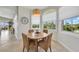 Cozy breakfast nook filled with natural light and a round wooden table with four wicker chairs at 196 Tarpon Cove Blvd # 722, Punta Gorda, FL 33950