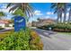 Scenic view of Tarpon Cove entrance with lush landscaping and palm trees, showcasing a serene neighborhood at 196 Tarpon Cove Blvd # 722, Punta Gorda, FL 33950