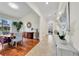 Open hallway connecting the dining room with hardwood floors to the entryway with tiled floors at 196 Tarpon Cove Blvd # 722, Punta Gorda, FL 33950