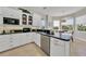 Bright kitchen with white cabinets, black countertops, stainless steel appliances, and a breakfast nook at 196 Tarpon Cove Blvd # 722, Punta Gorda, FL 33950
