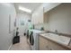 Functional laundry room with washer, dryer, sink, and storage cabinets, providing convenience at 196 Tarpon Cove Blvd # 722, Punta Gorda, FL 33950