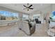 Open living room with neutral tones, tile floors, large windows, and comfortable furnishings at 196 Tarpon Cove Blvd # 722, Punta Gorda, FL 33950