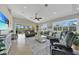Spacious living room with tile floors, a ceiling fan, large windows, and comfortable seating at 196 Tarpon Cove Blvd # 722, Punta Gorda, FL 33950