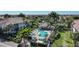 Aerial view of a private community pool with lush landscaping and comfortable seating options at 196 Tarpon Cove Blvd # 722, Punta Gorda, FL 33950