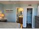 Bright bedroom featuring ensuite bath and closet, blue walls, and neutral decor at 21405 Olean Blvd # 531, Port Charlotte, FL 33952