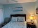 Bedroom featuring a queen size bed, cool-toned walls, and neutral decor at 21405 Olean Blvd # 531, Port Charlotte, FL 33952