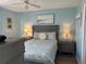 Cozy bedroom featuring a queen bed, soft blue walls, and beach-themed decor at 21405 Olean Blvd # 531, Port Charlotte, FL 33952
