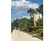 Entrance to community displays signage, lush landscaping, and a welcoming pathway at 21405 Olean Blvd # 531, Port Charlotte, FL 33952