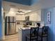 Updated kitchen with stainless steel appliances, granite countertops, and white cabinets at 21405 Olean Blvd # 531, Port Charlotte, FL 33952