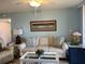 Comfortable living room with couch, decorative pillows, and ceiling fan at 21405 Olean Blvd # 531, Port Charlotte, FL 33952