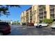 Condo building with palm trees and ample parking spaces for residents and visitors at 21405 Olean Blvd # 531, Port Charlotte, FL 33952
