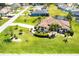 A home features lush landscaping and is complemented by an American flag at 25179 Campos Dr, Punta Gorda, FL 33983