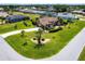 Expansive single-story home with a well-manicured lawn, circular driveway, and a screened-in pool at 25179 Campos Dr, Punta Gorda, FL 33983