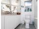 Bright bathroom featuring a white vanity, toilet, and decorative accents at 25179 Campos Dr, Punta Gorda, FL 33983