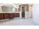 Full bathroom featuring a walk-in shower, granite counters and a large mirror at 25179 Campos Dr, Punta Gorda, FL 33983