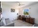 Bright bedroom features a ceiling fan, natural light, desk, and comfortable seating at 25179 Campos Dr, Punta Gorda, FL 33983