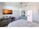 Well-lit bedroom featuring a ceiling fan, TV, and custom-painted furniture at 25179 Campos Dr, Punta Gorda, FL 33983
